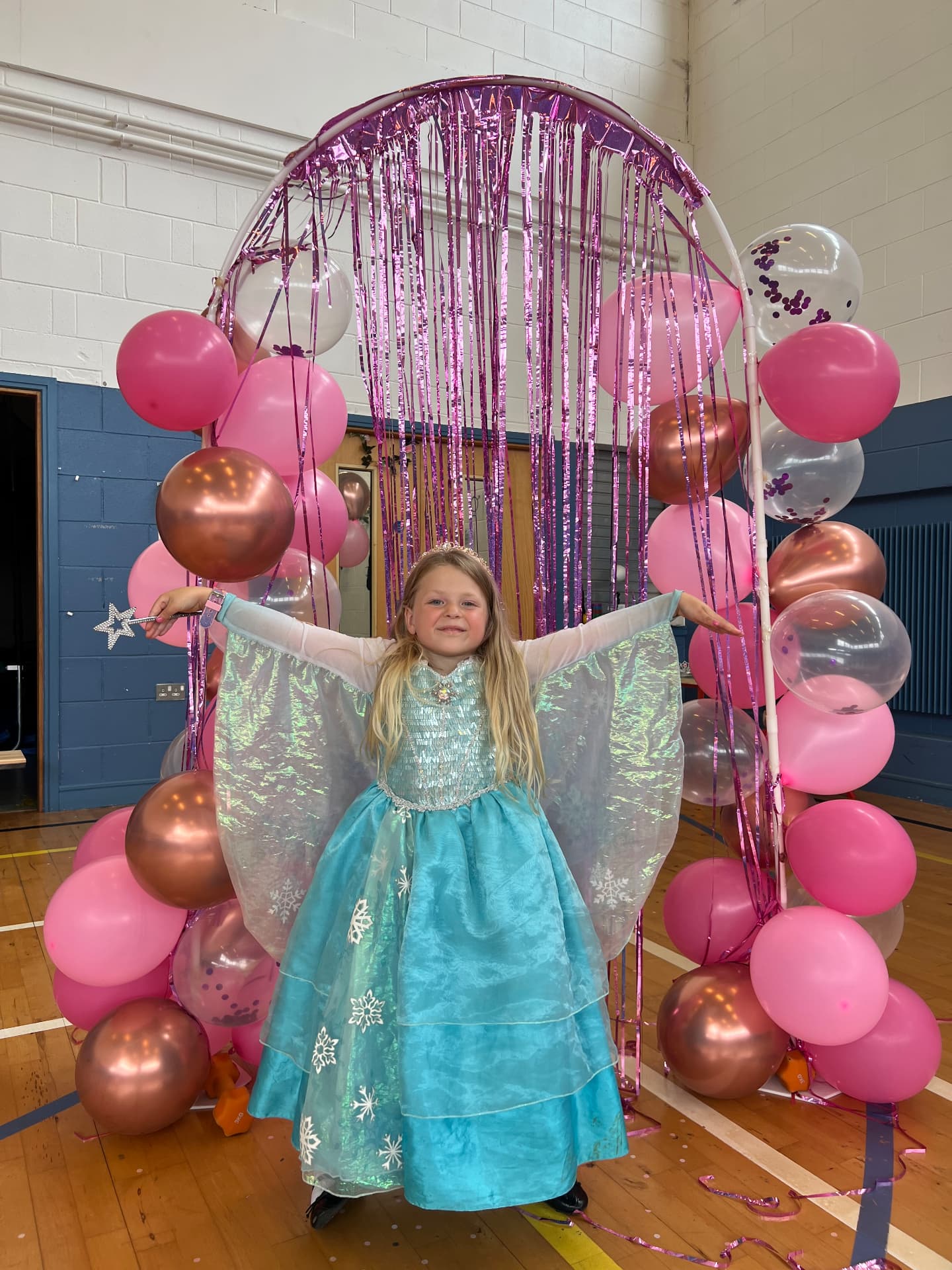 Young dancer in a sparkling Elsa costume enjoying a themed party at ballet camp